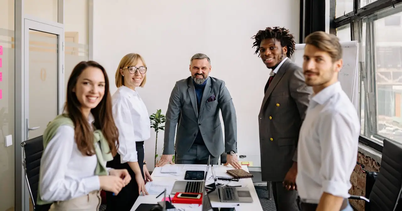 A group of diverse business professionals standing together in a modern office setting