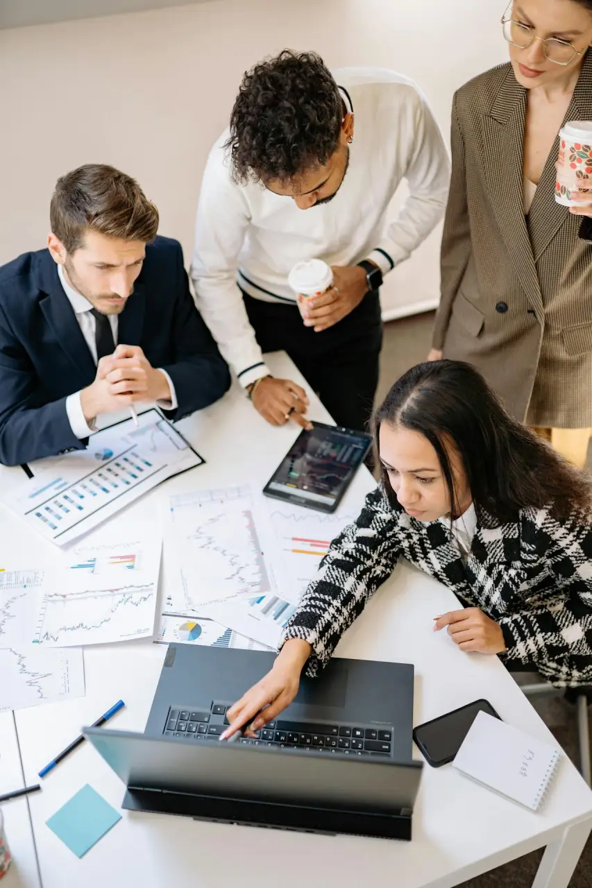 Business professionals collaborating around a table, discussing ideas and strategies in a modern office setting