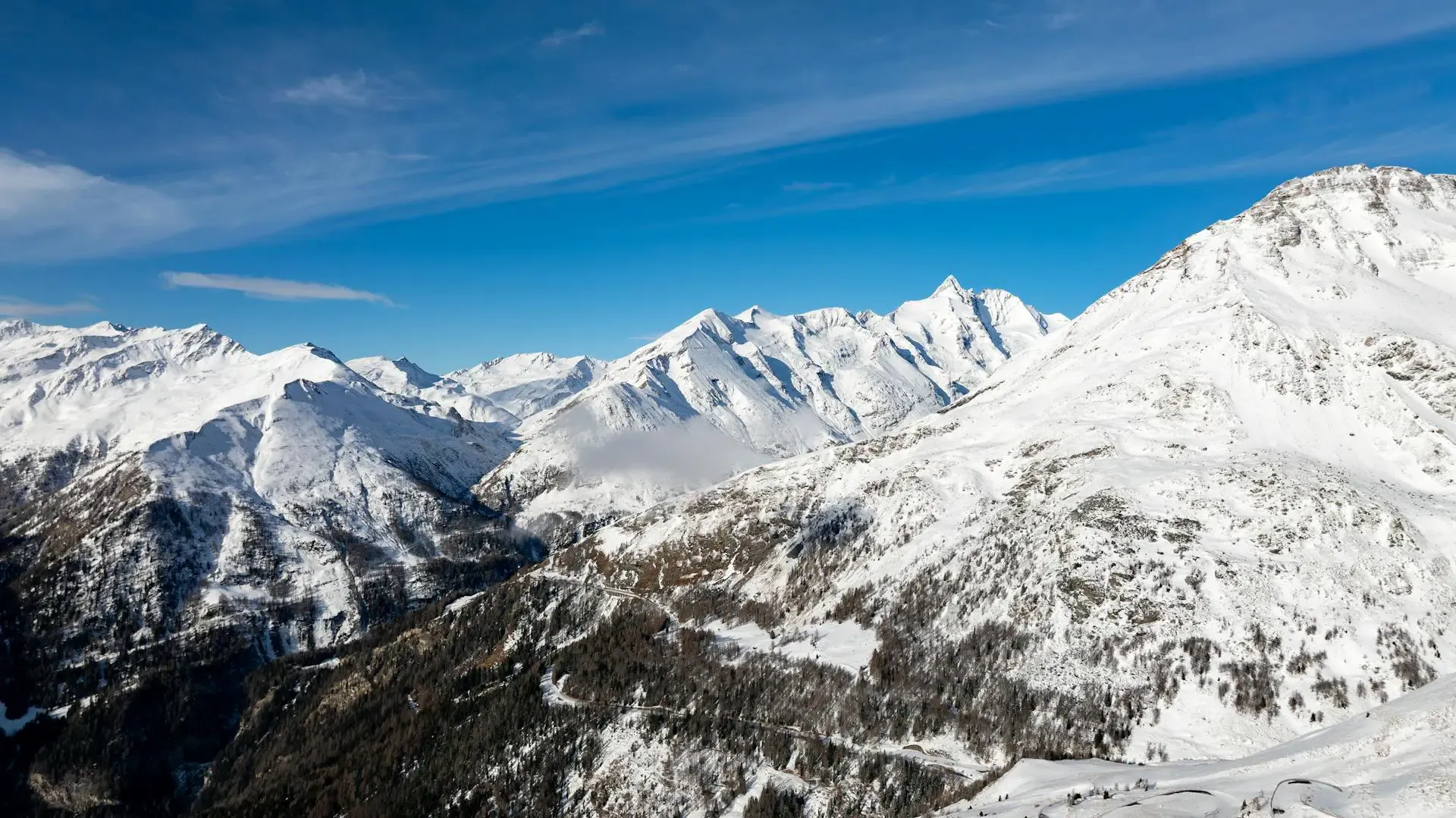 A panoramic view of majestic mountains from a mountain top